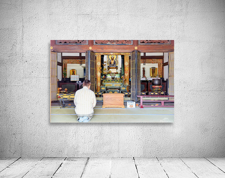 Man prays at Senso ji temple in Asakusa Tokyo Japan Wall Preview