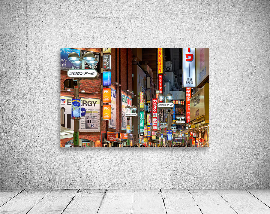 Neon lights shine bright in Shibuya district at night in Tokyo Wall Preview