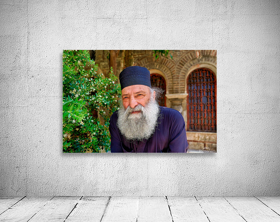 Elderly man with a beard poses near a historical building in a g Wall Preview