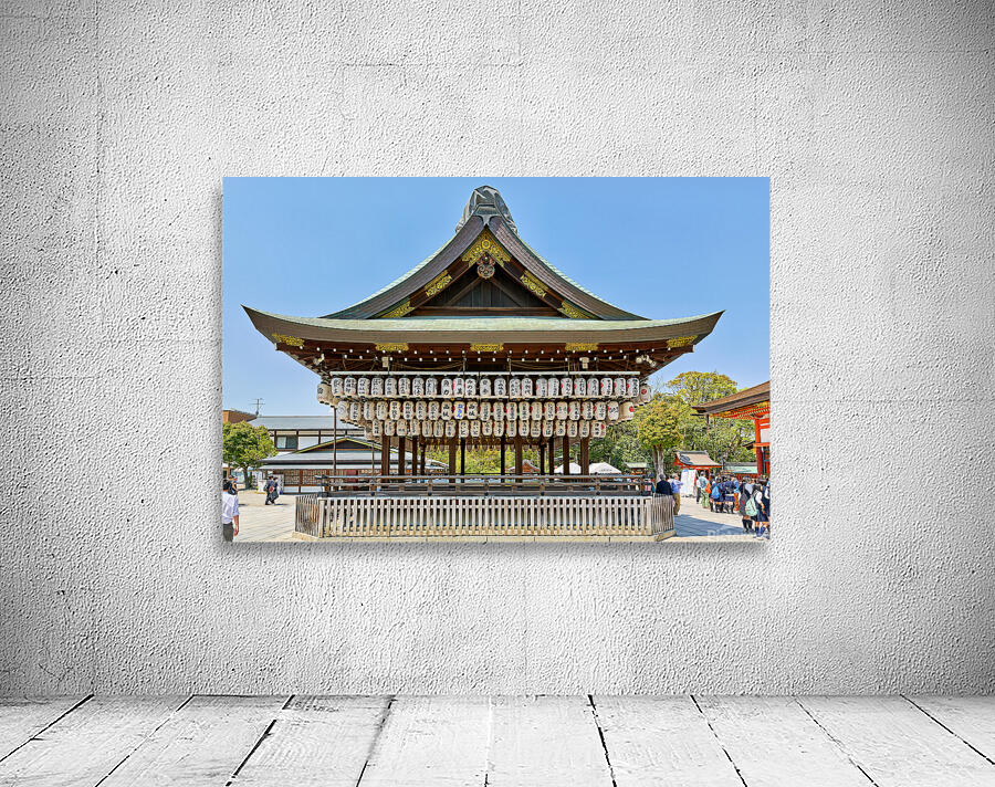 Visitors admire Yasaka shrine in Kyoto during sunny day Wall Preview