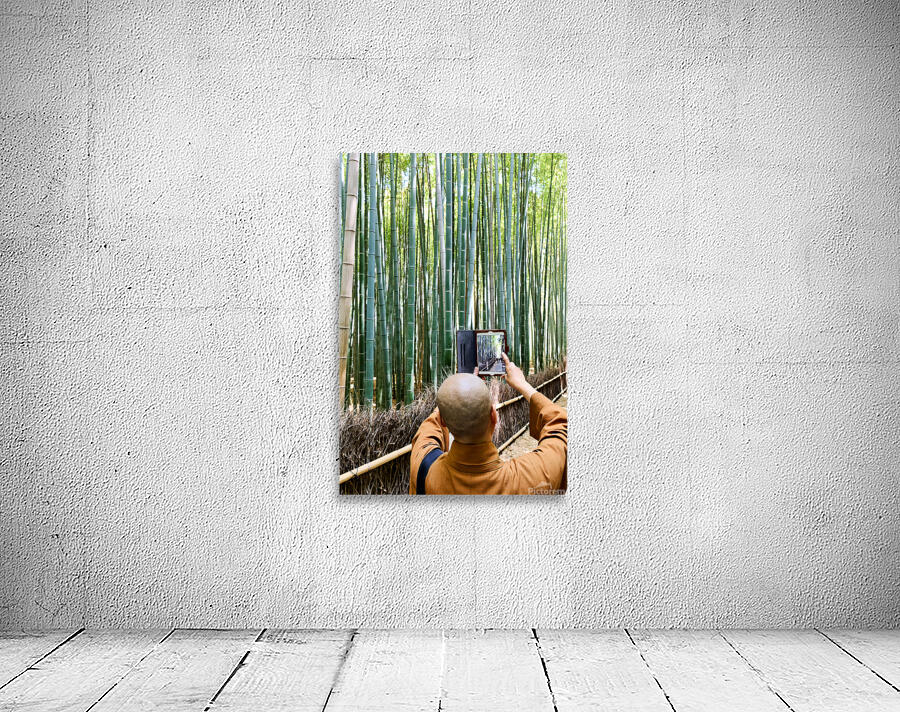 Buddhist monk takes pictures in Arashiyama Bamboo Grove in Japan Wall Preview