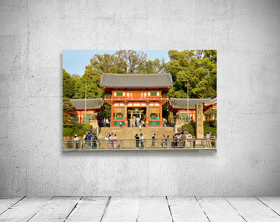 Kyoto Yasaka shrine temple with visitors and trees in background Wall Preview
