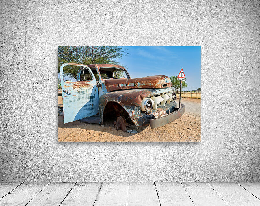 Classic car wreck in Namibias desert environment Wall Preview