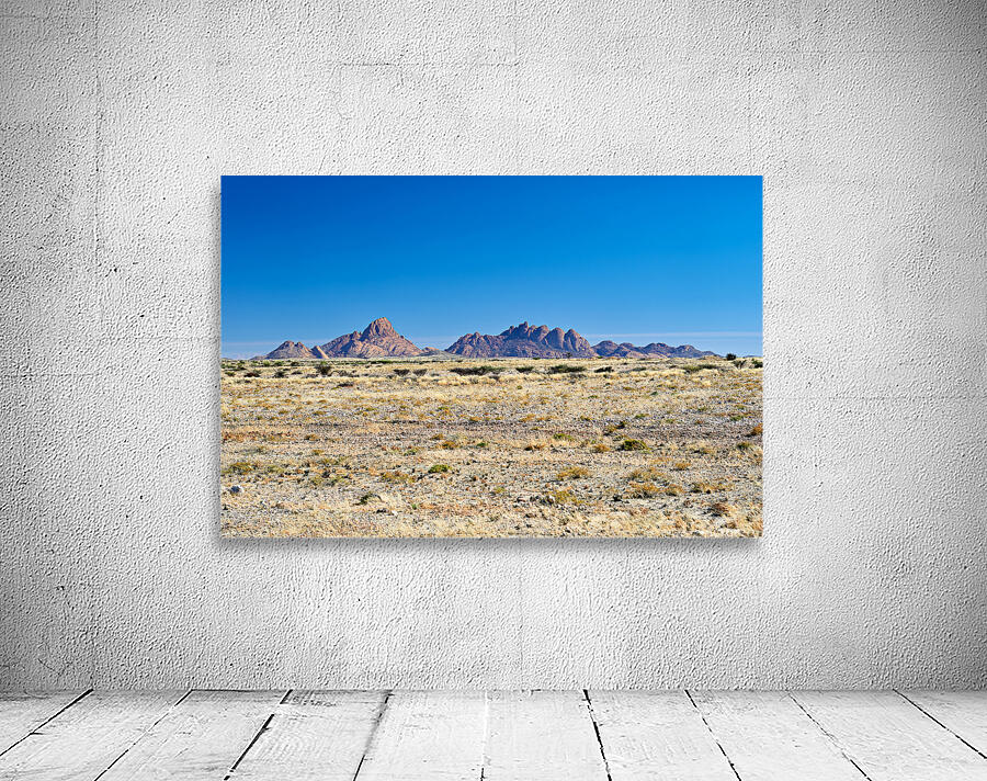 Granite peaks of Spizkoppe rise in Namib Desert landscape Wall Preview