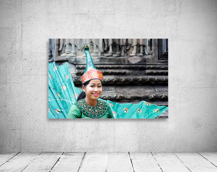 Smiling Cambodian dancer in traditional peacock costume at templ Wall Preview