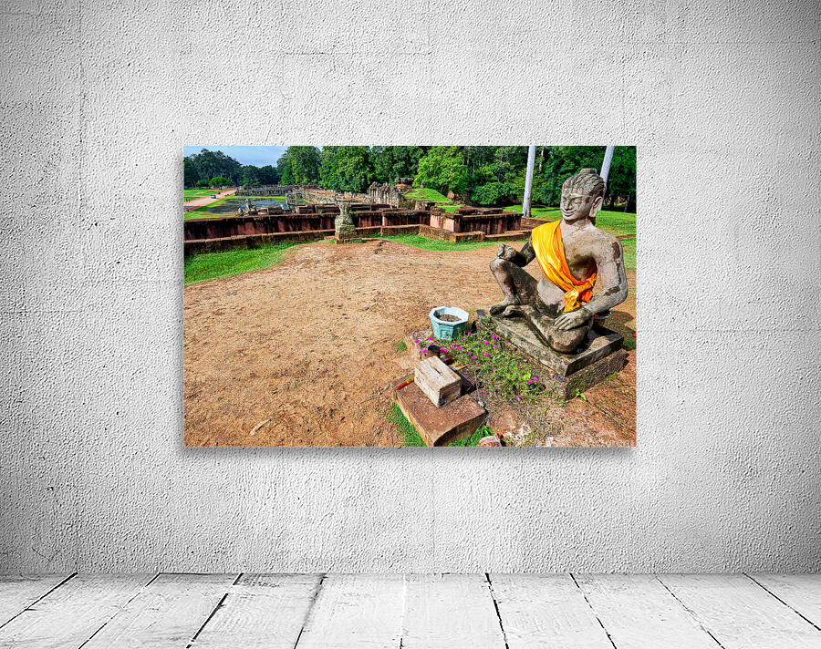 Ancient statue overlooks temple ruins amidst lush greenery. Wall Preview
