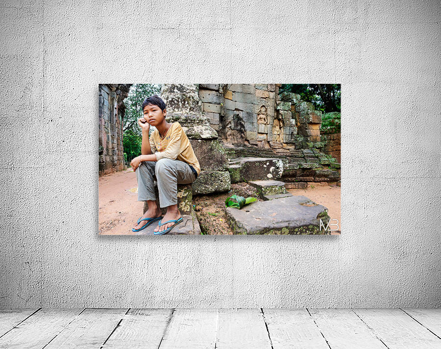 Young person sits on ancient temple ruins. Wall Preview