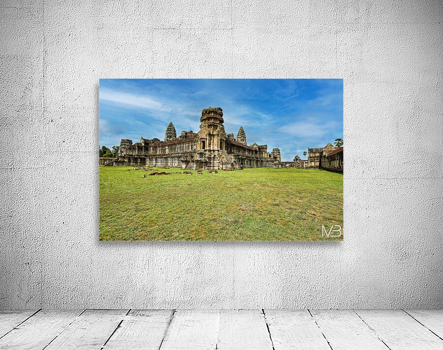 Angkor Wat temple complex with green grass and blue sky. Wall Preview
