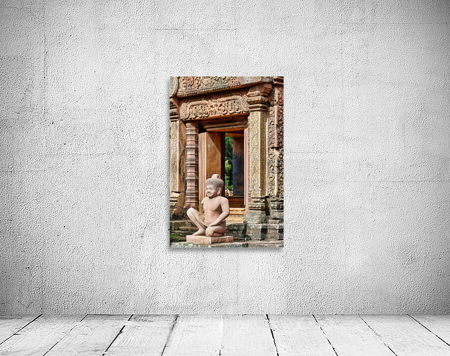 Ancient Cambodian temple with intricate carvings and stone statu Wall Preview