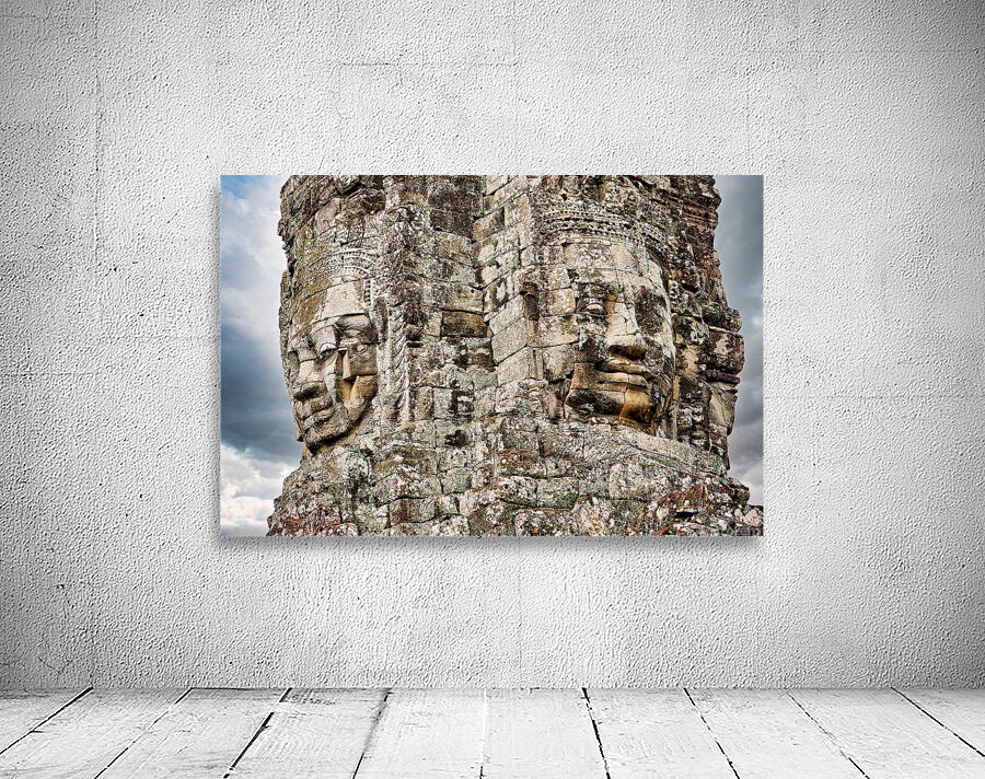 Ancient stone faces carved into Bayon Temple Cambodia. Wall Preview