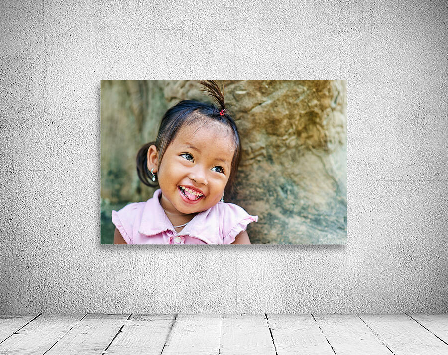 Joyful young girl with a playful smile and tongue out. Wall Preview