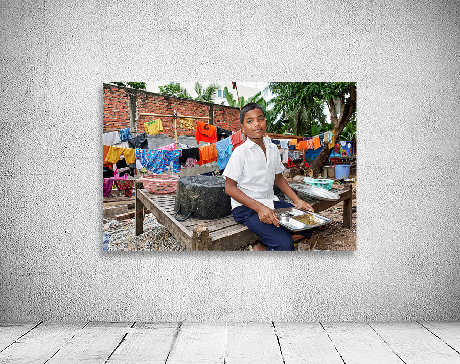 Boy with food tray clothes drying in background. Wall Preview