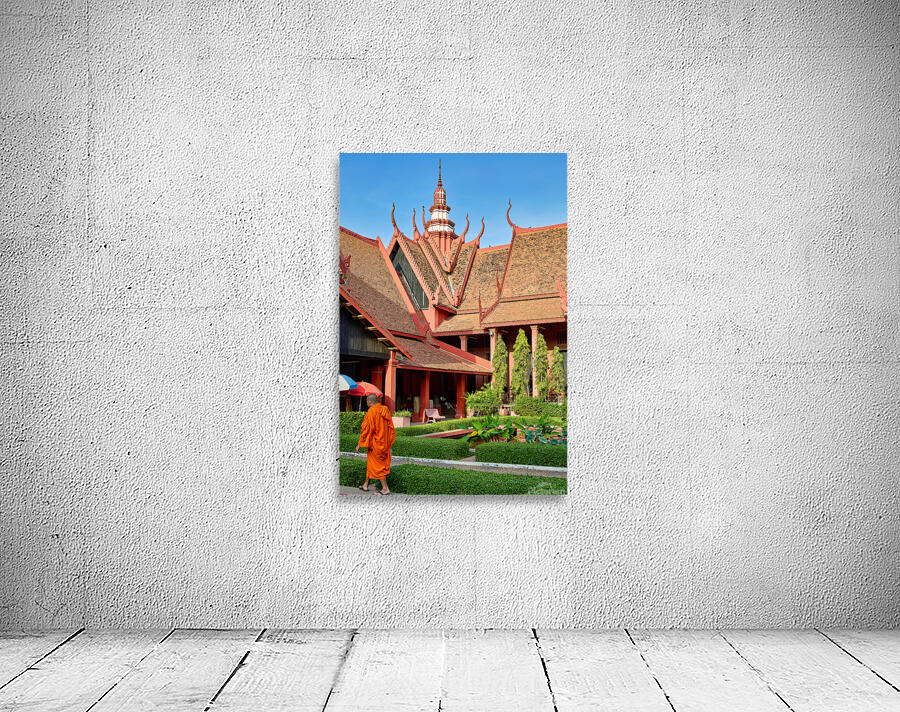 Monk walks through traditional Cambodian temple garden. Wall Preview