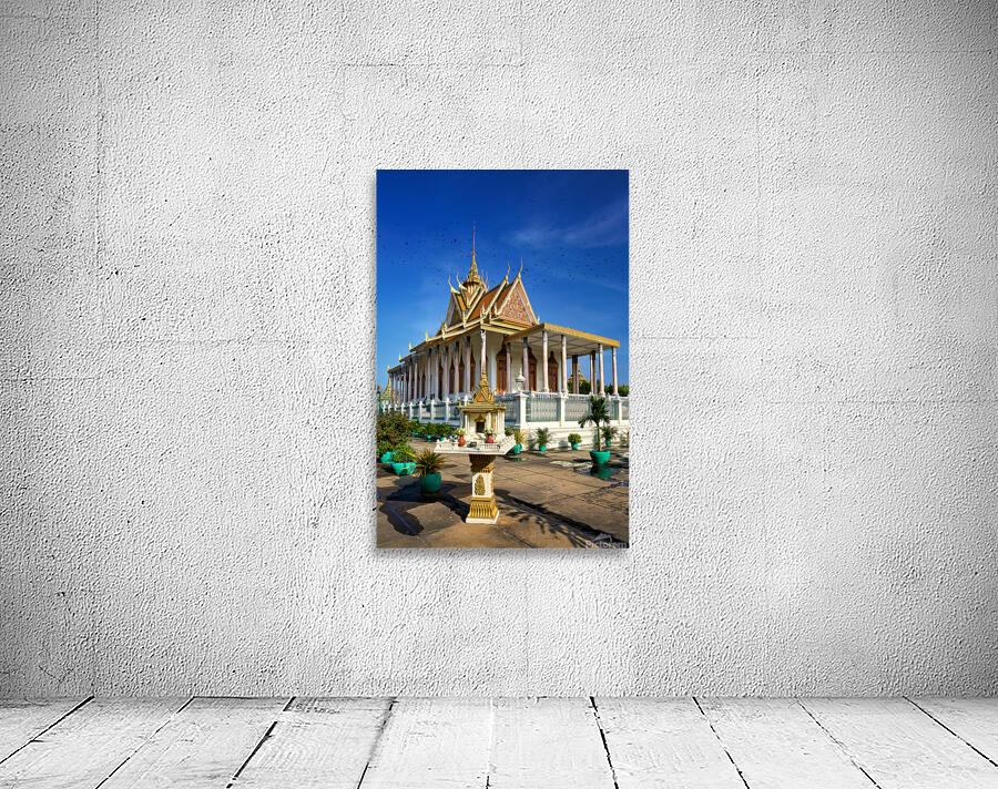 Majestic Cambodian temple under a blue sky with flying birds. Wall Preview