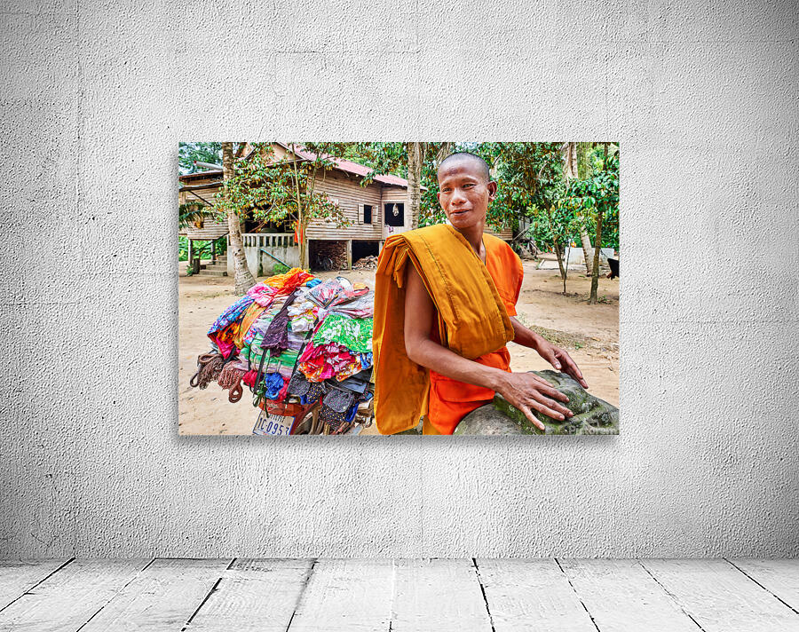 Monk with colorful textiles on a motorcycle. Wall Preview