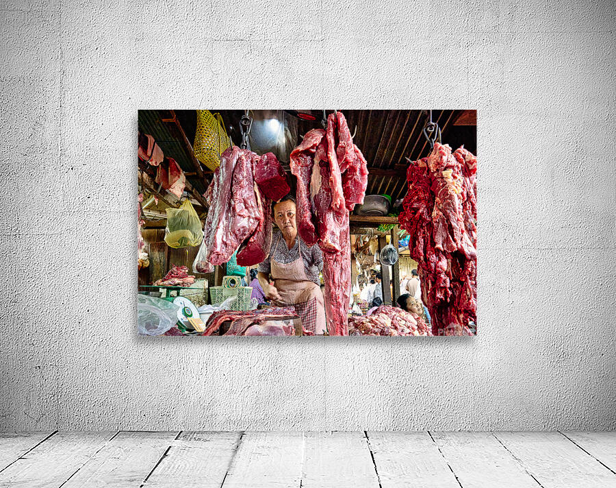 Woman selling raw meat in a bustling market. Wall Preview