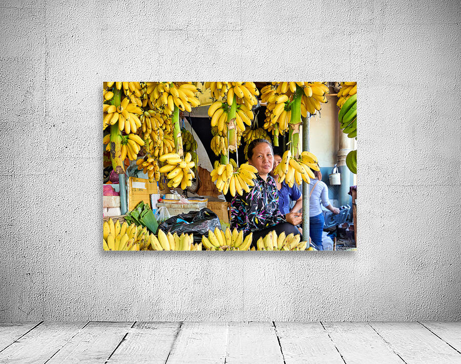 Market vendor surrounded by abundant yellow bananas. Wall Preview