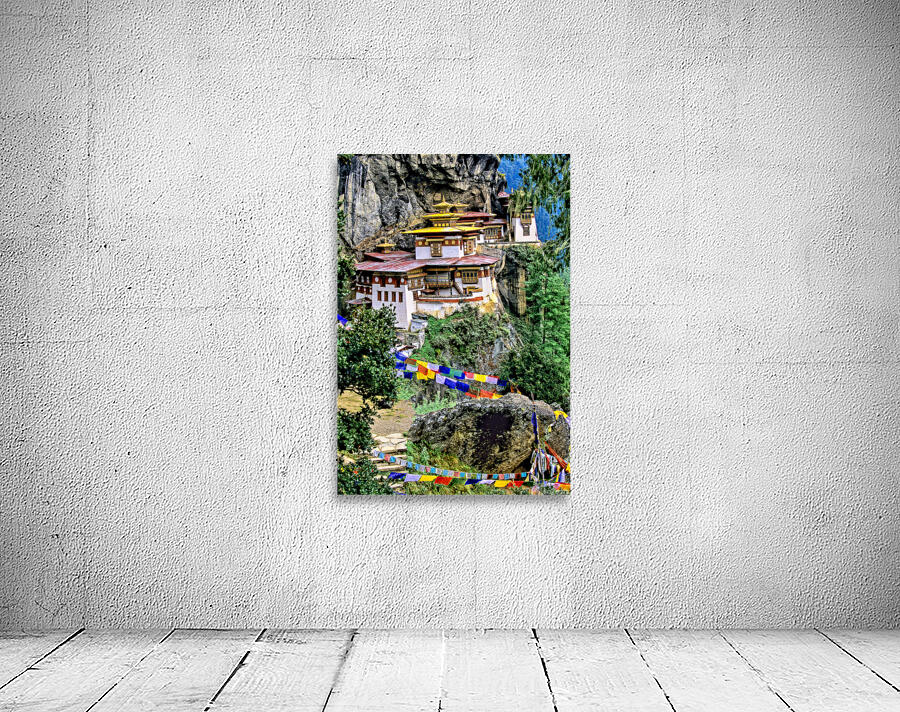 Iconic Bhutanese monastery on a cliff surrounded by prayer flag Wall Preview