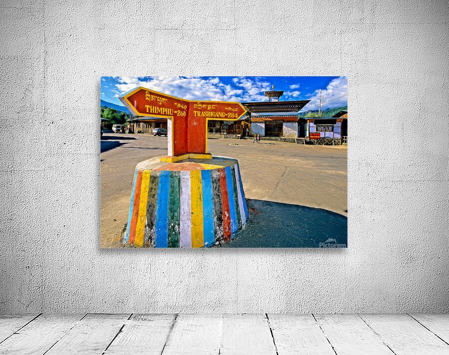 Colorful Bhutanese signpost directs to Thimphu and Trashigang. Wall Preview