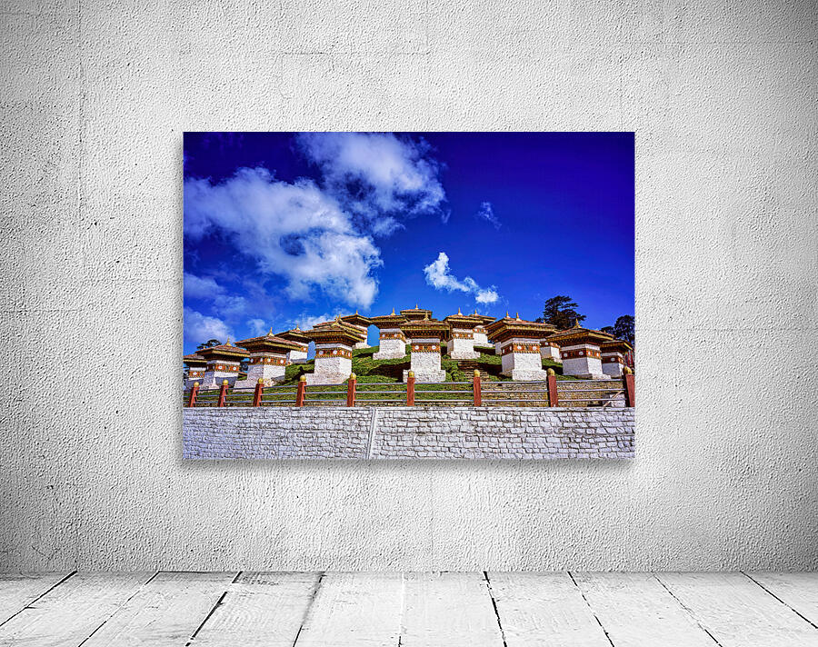 Traditional Bhutanese chortens on a green hill blue sky. Wall Preview
