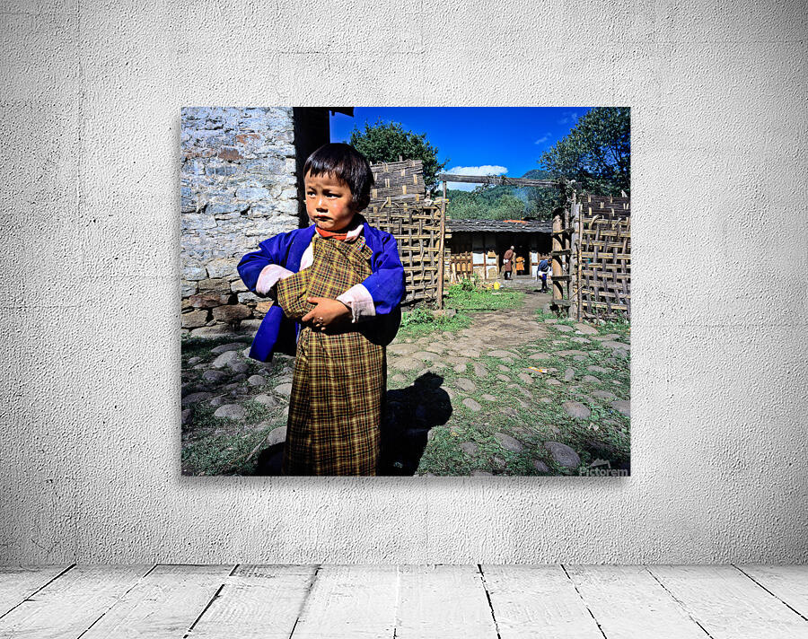 Young child in traditional Bhutanese dress in village. Wall Preview
