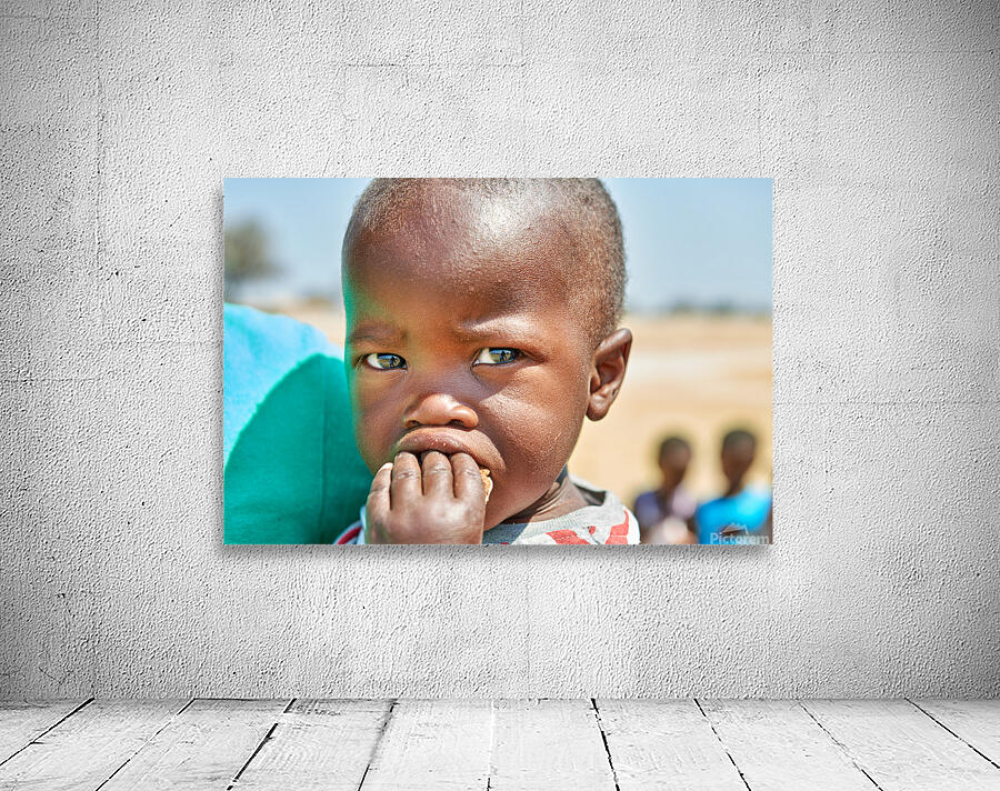 Sad boy in Kavango Region of Namibia looks thoughtful and lost Wall Preview
