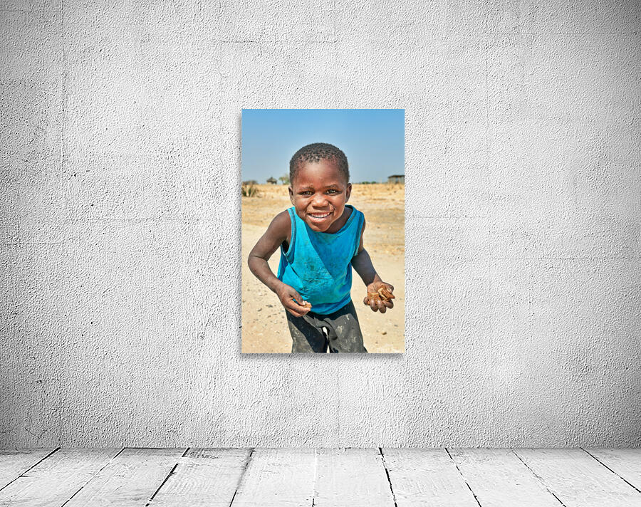 Joyful boy in Kavango Region of Namibia enjoys a moment outside Wall Preview