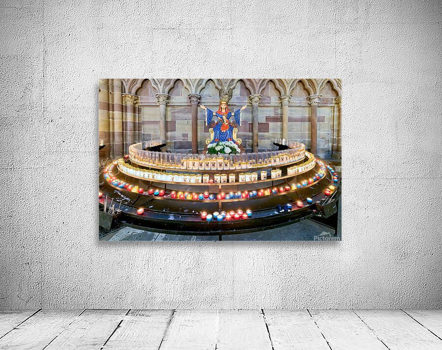 Visitors light votive candles near statue in Strasbourg Cathedra Wall Preview