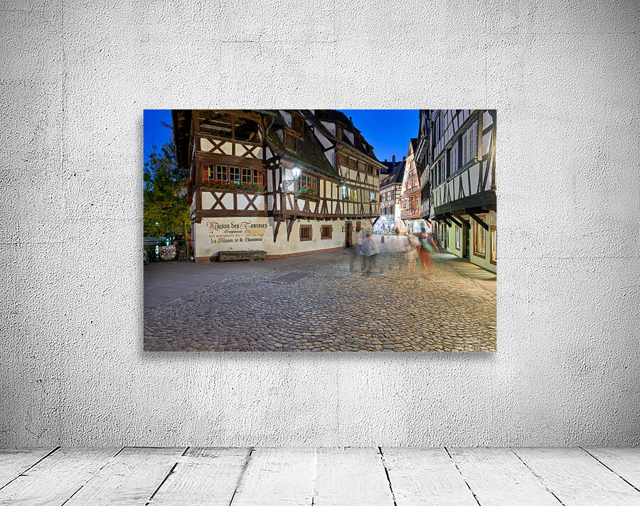 Colorful timber houses and people walking in Strasbourg at night Wall Preview