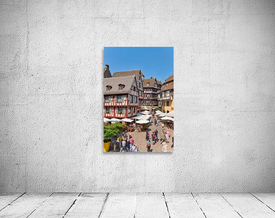 Visitors walk through Colmar on sunny day near timber framed hou Wall Preview