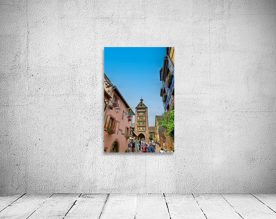 Tourists stroll through historic streets in Riquewihr Alsace Wall Preview