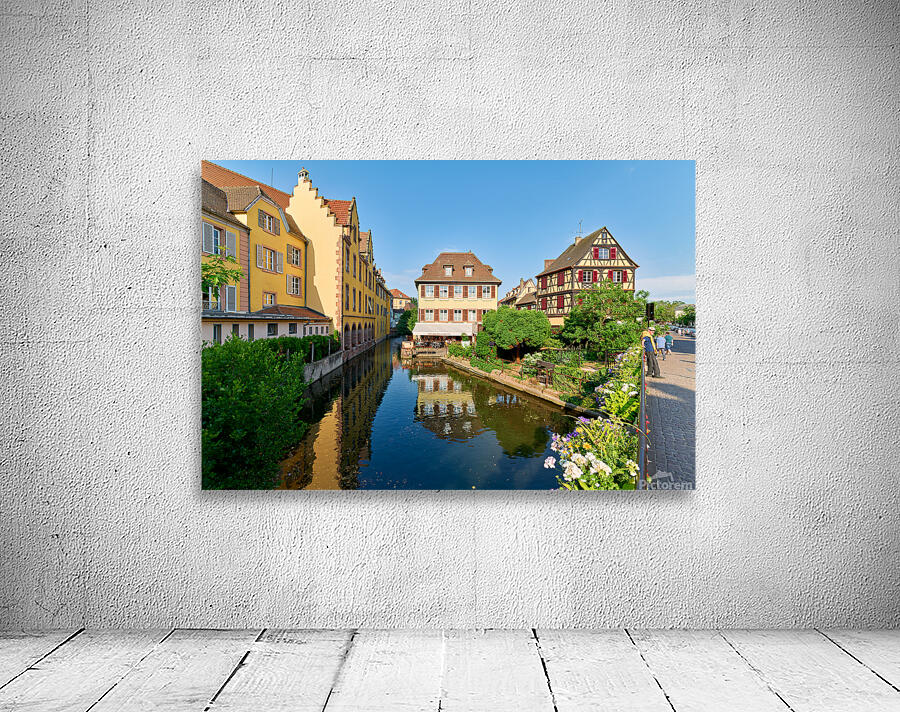 Visitors enjoy sunny day by canals in Colmar France Wall Preview