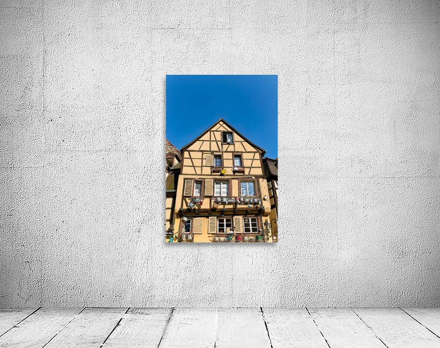 Timber framed houses in Colmar with clear blue sky above Wall Preview