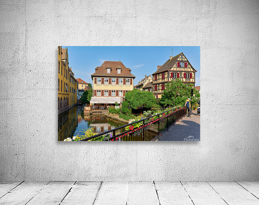 Visitors stroll by timber framed houses along the canal in Colma Wall Preview