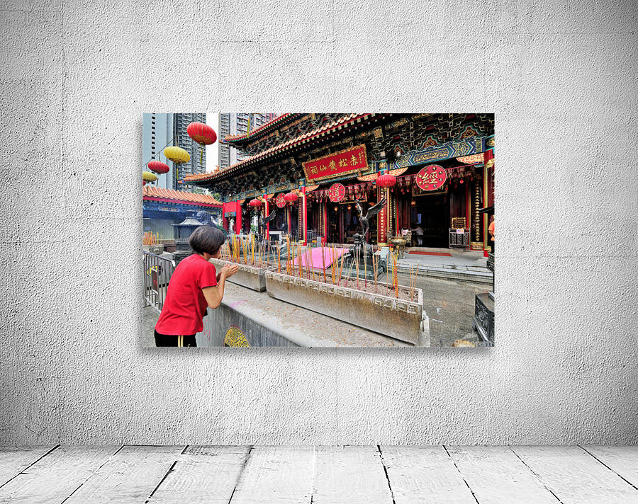 Woman prays with incense at colorful Chinese temple in Hong Kong Wall Preview