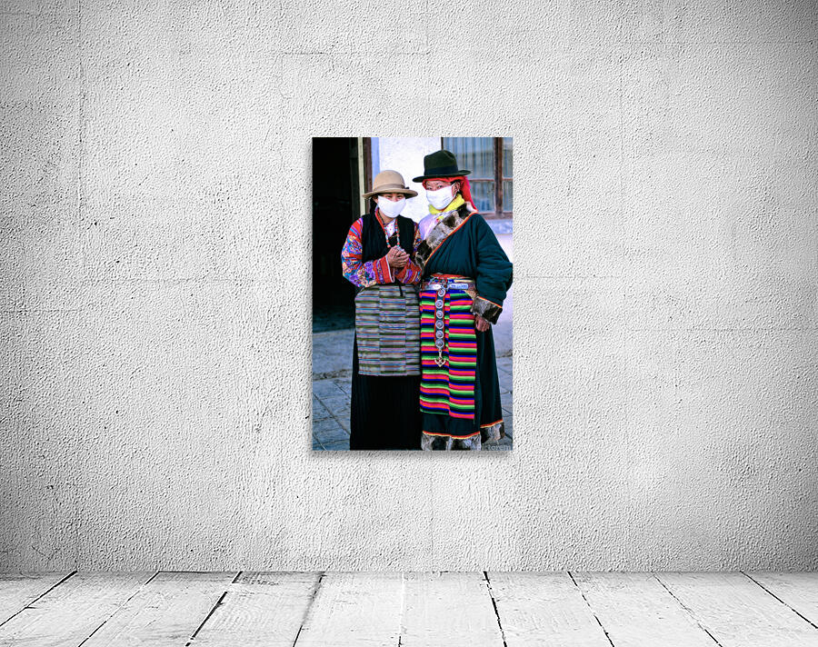 Masked individuals in traditional clothing hold hands in Tibet Wall Preview