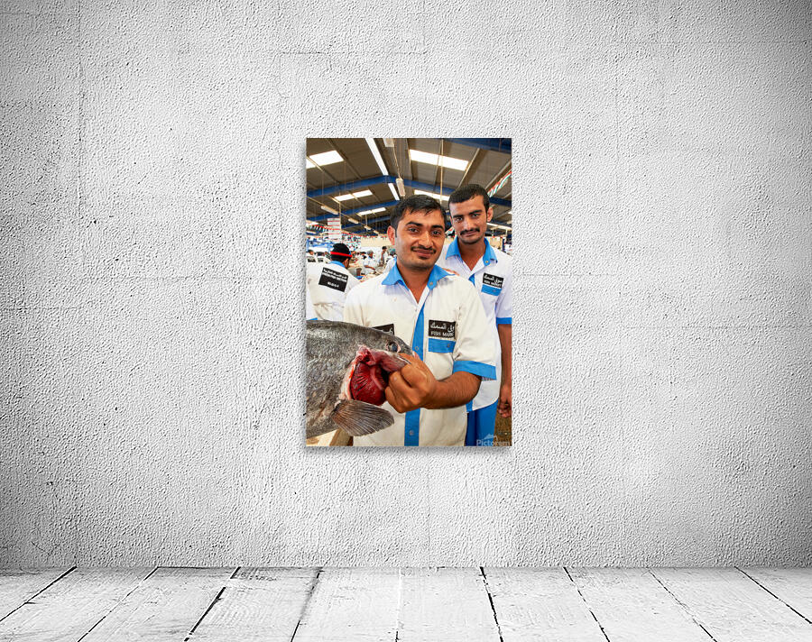 Smiling fishmongers hold fresh fish at market in Dubai UAE Wall Preview