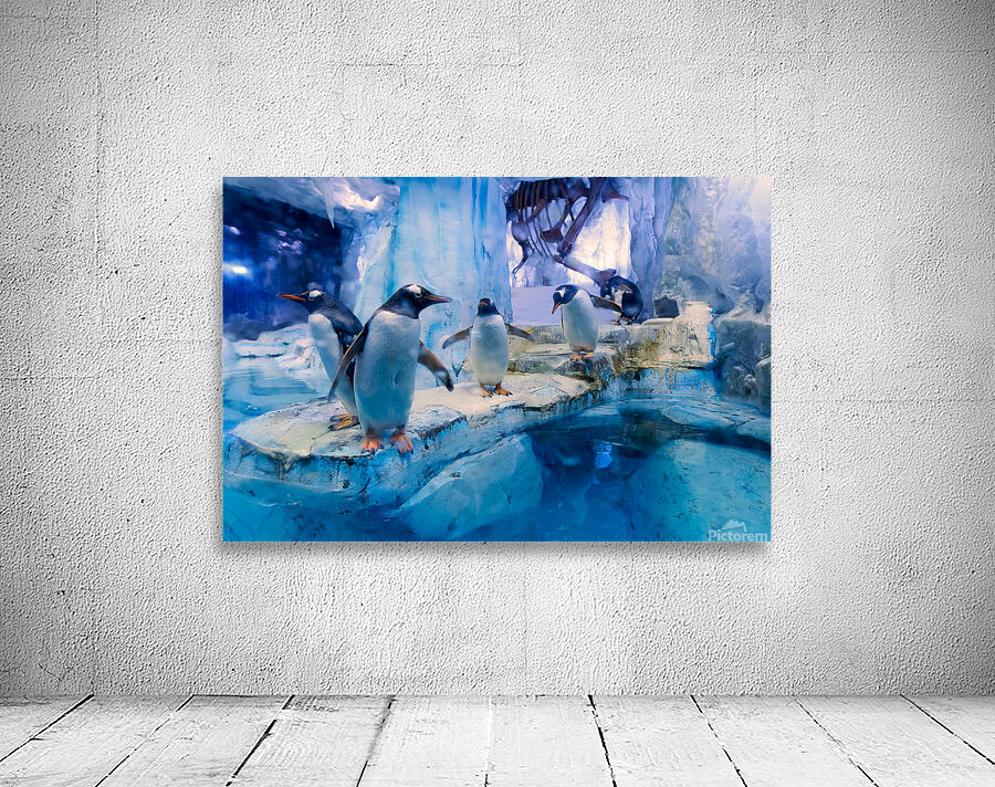 Penguins play on ice near water with a skeleton exhibit in Dubai Wall Preview