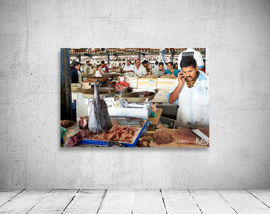 Man talks on phone at busy fish market in Dubai UAE Wall Preview