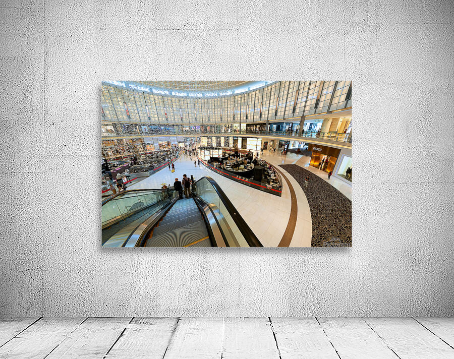 Busy shopping mall in Dubai with escalators and various stores Wall Preview