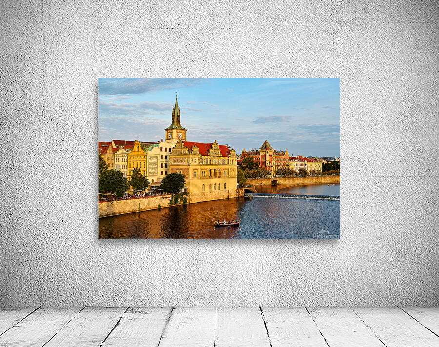 Sunset over Pragues Vltava River historic buildings and boat. Wall Preview