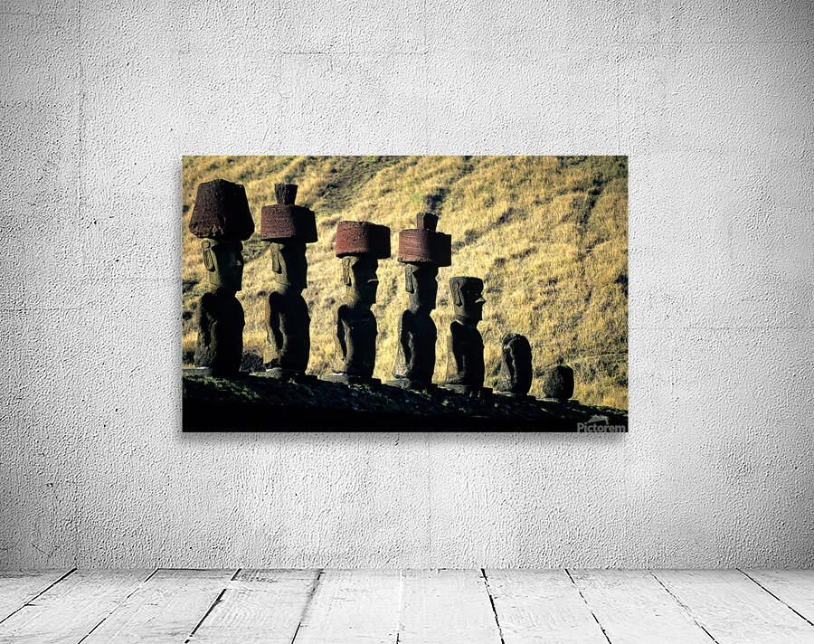 Easter Island Moai statues with red hats on a hillside. Wall Preview