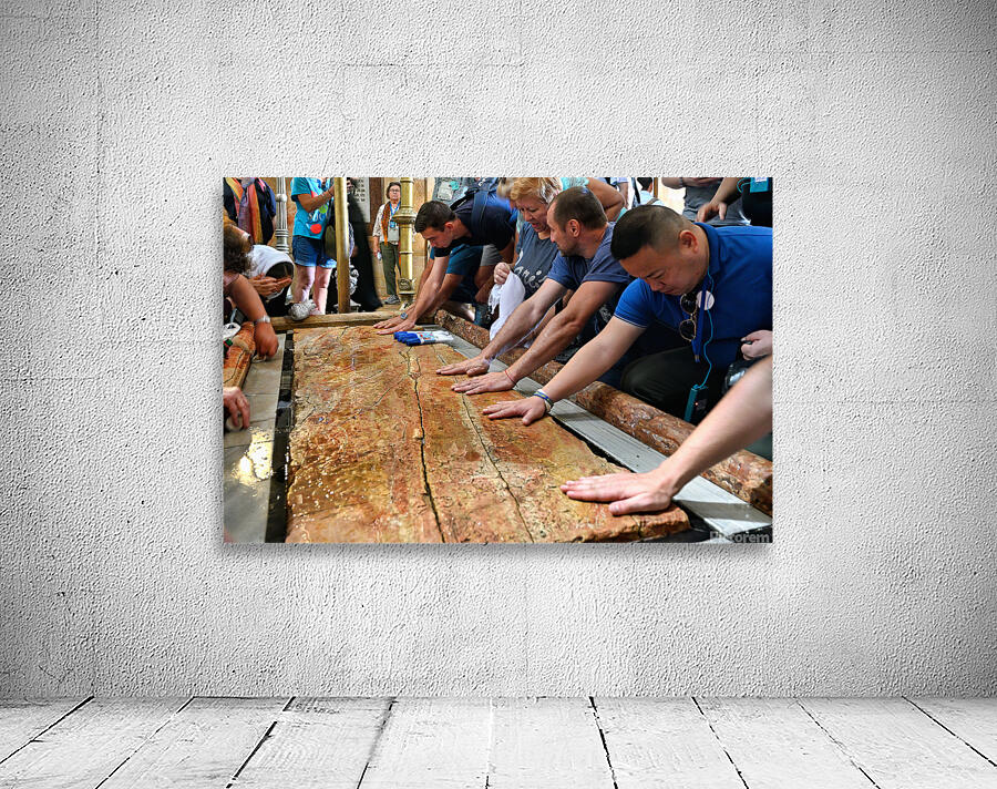 Visitors touch the stone of unction in the Holy Sepulchre Wall Preview