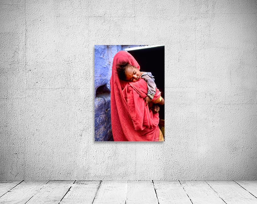 Mother carries sleeping child in India during daytime Wall Preview