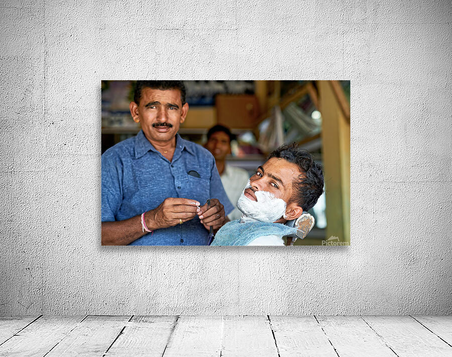 Barber at work in Khimsar Rajasthan India during a busy day Wall Preview