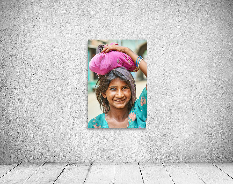 Portrait of a young girl carrying cloth in Mandawa Rajasthan Wall Preview