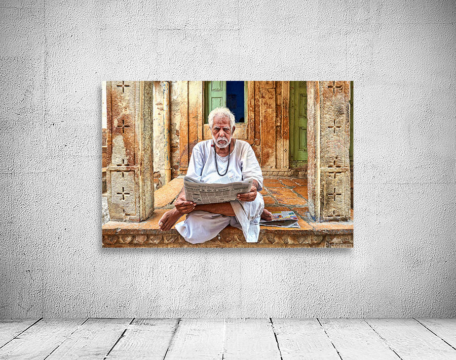 Man reads newspaper on street in Jaisalmer Rajasthan India Wall Preview