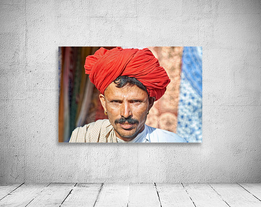 Man in red turban poses in Rajasthans Jaisalmer market street Wall Preview