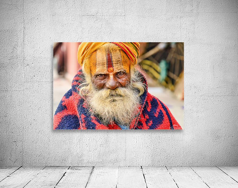 Old holy man in Varanasi wearing bright colors in Uttar Pradesh Wall Preview