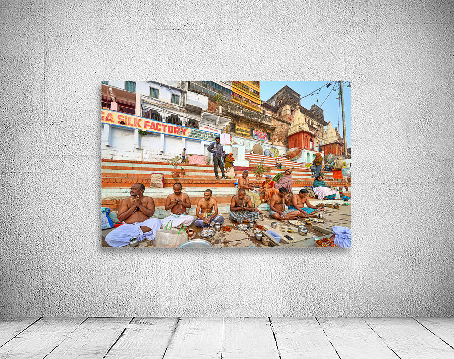 Barechested men offer prayers by the Ganges River in Varanasi Wall Preview